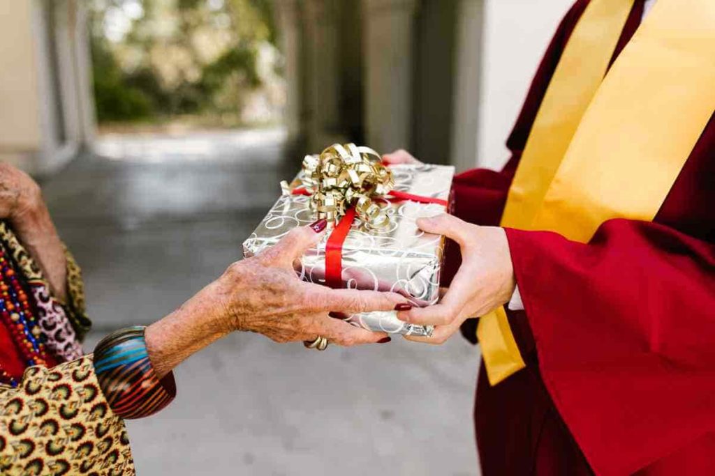 woman handing out a graduation gift