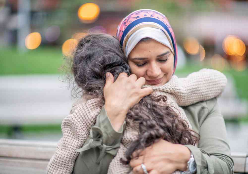 woman hugging a kid